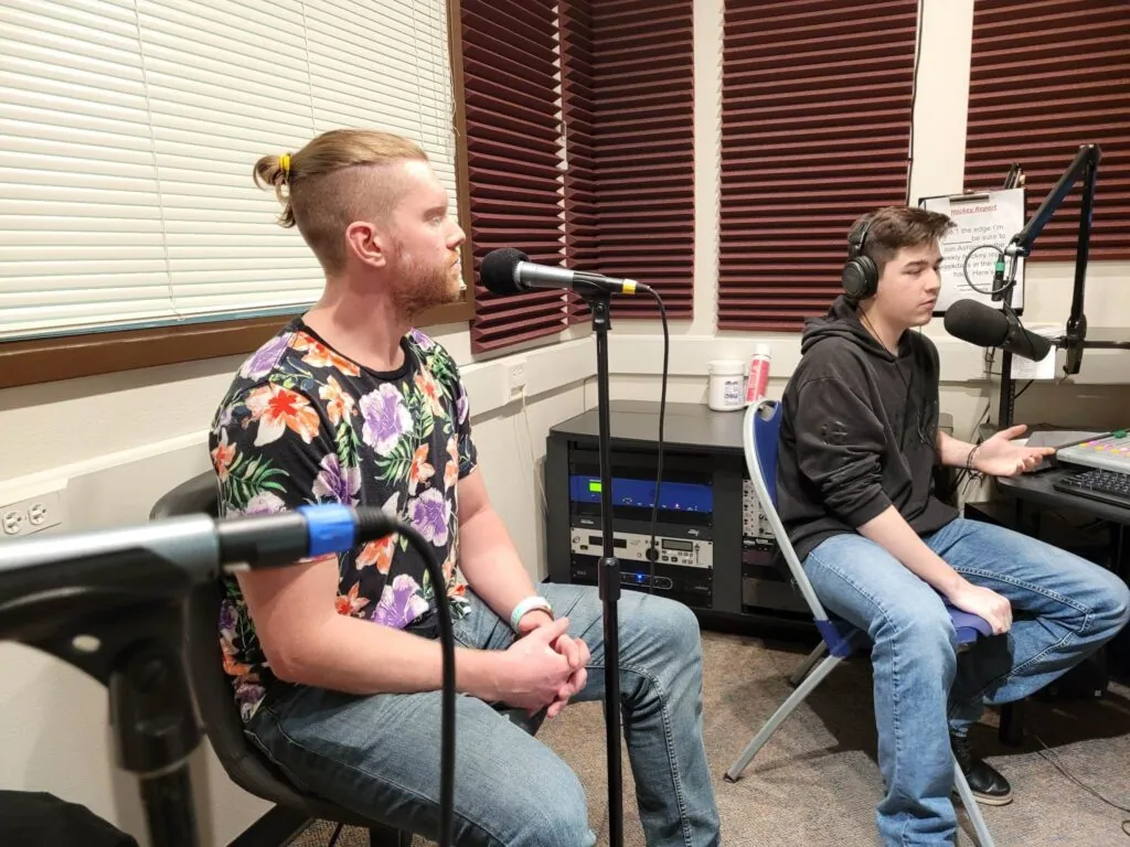 One of us at the mic in the studio at 88.1 The Edge, with the student host in headphones at the broadcast desk.