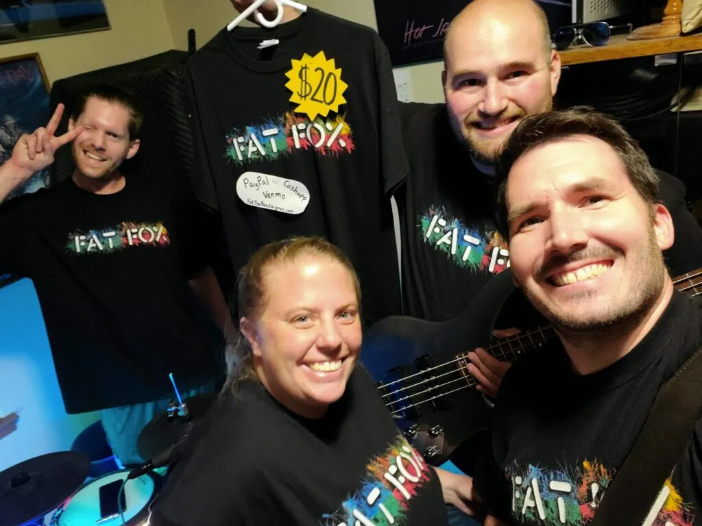 The four of us in our new Fat Fox t-shirts, with one more on a hanger behind us marked $20.