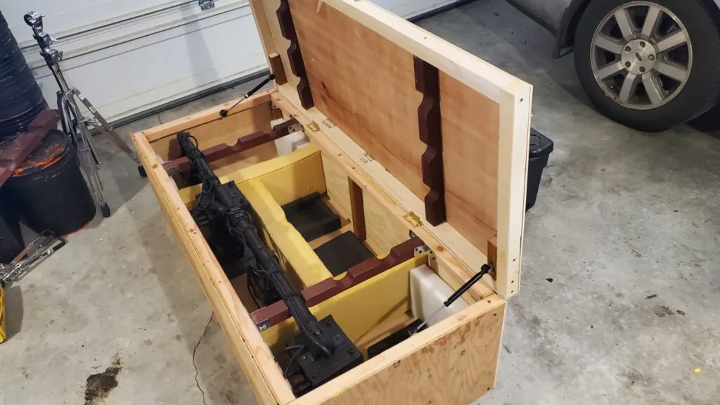 Our finished lighting crate with its lid propped open, the lighting rig resting in custom-cut slots inside.